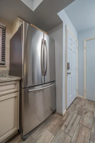 a metallic refrigerator freezer sitting in a kitchen