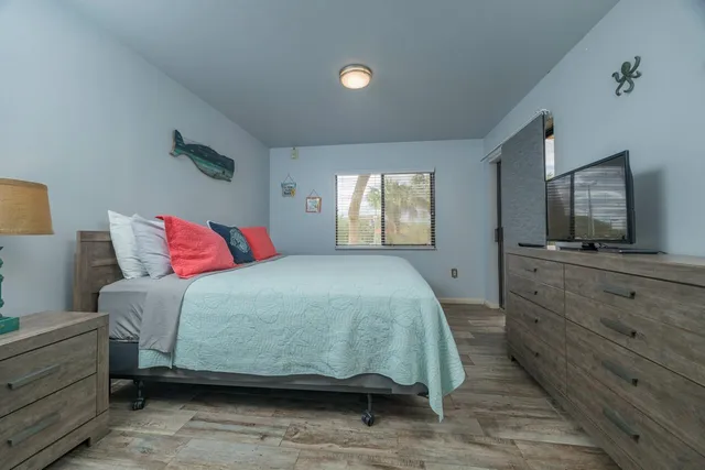 a living room with furniture a ceiling fan and a large window