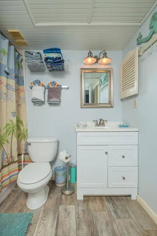 a bathroom with a granite countertop toilet sink and a mirror