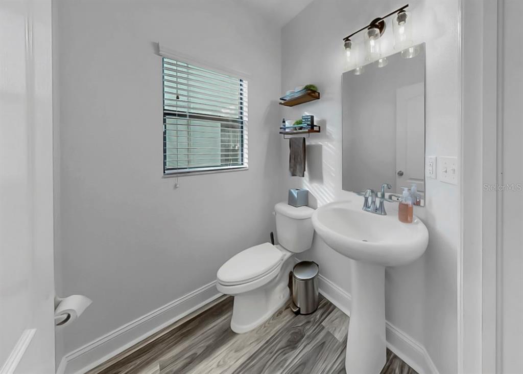 10136 Newminster Loop Ruskin, FL 33573 - Photo 13 of 64 a bathroom with a sink toilet and a mirror