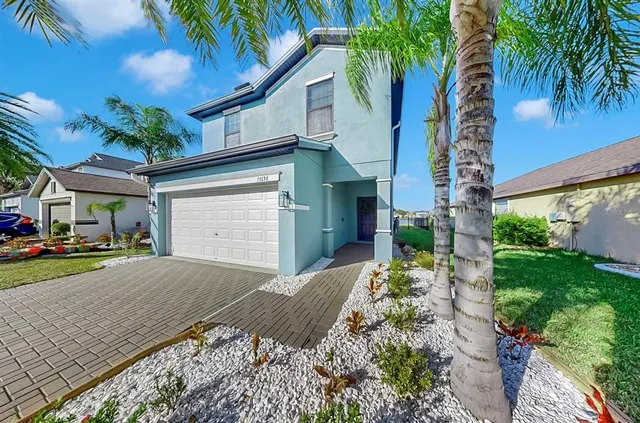 a living room with stainless steel appliances furniture and a kitchen view