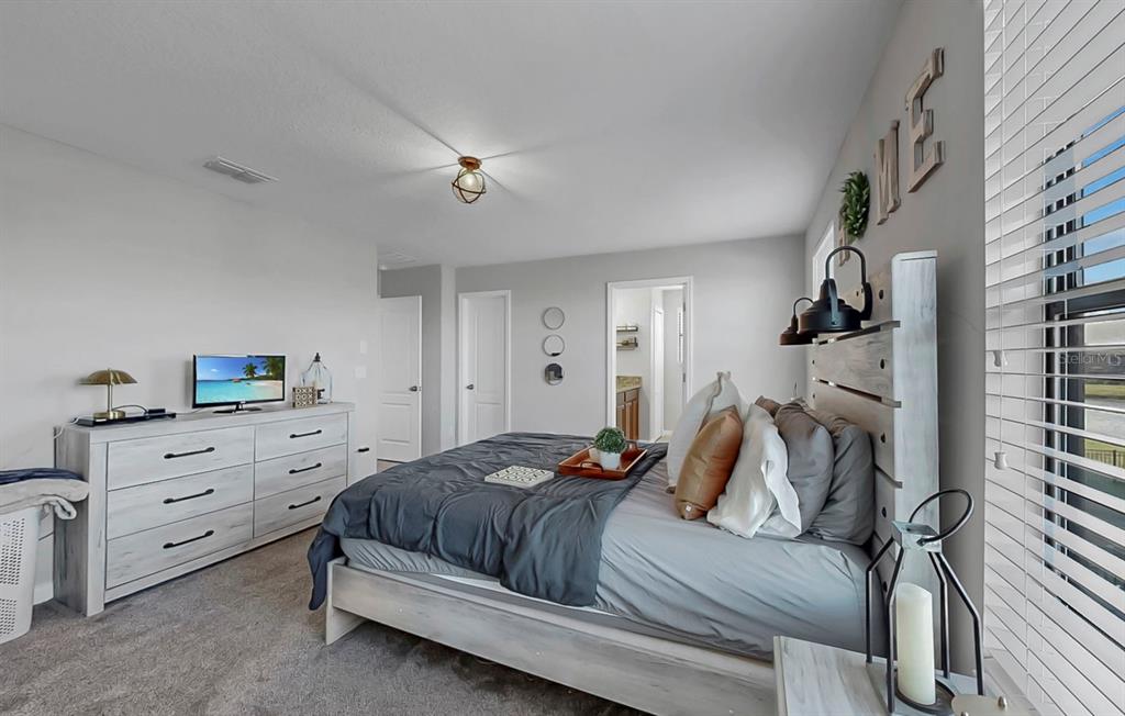 10136 Newminster Loop Ruskin, FL 33573 - Photo 26 of 64 a bedroom with a bed and a window