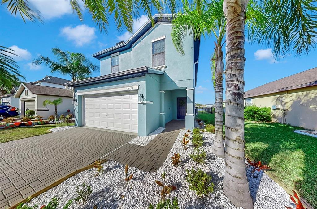 10136 Newminster Loop Ruskin, FL 33573 - Photo 27 of 64 a front view of a house with garden and patio