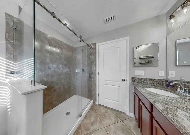 a kitchen with kitchen island granite countertop stainless steel appliances cabinets a sink and a counter top space