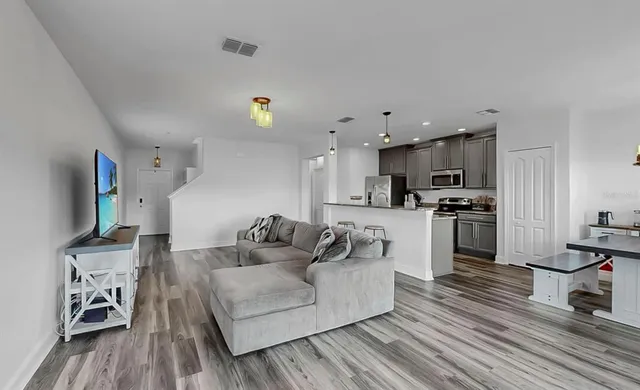 a kitchen with stainless steel appliances a refrigerator sink and stove