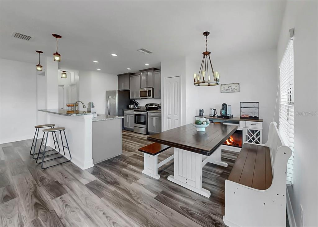 10136 Newminster Loop Ruskin, FL 33573 - Photo 36 of 64 a kitchen with stainless steel appliances granite countertop a sink stove and refrigerator