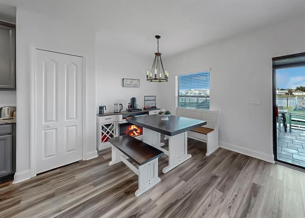 10136 Newminster Loop Ruskin, FL 33573 - Photo 41 of 64 a living room with furniture and a chandelier