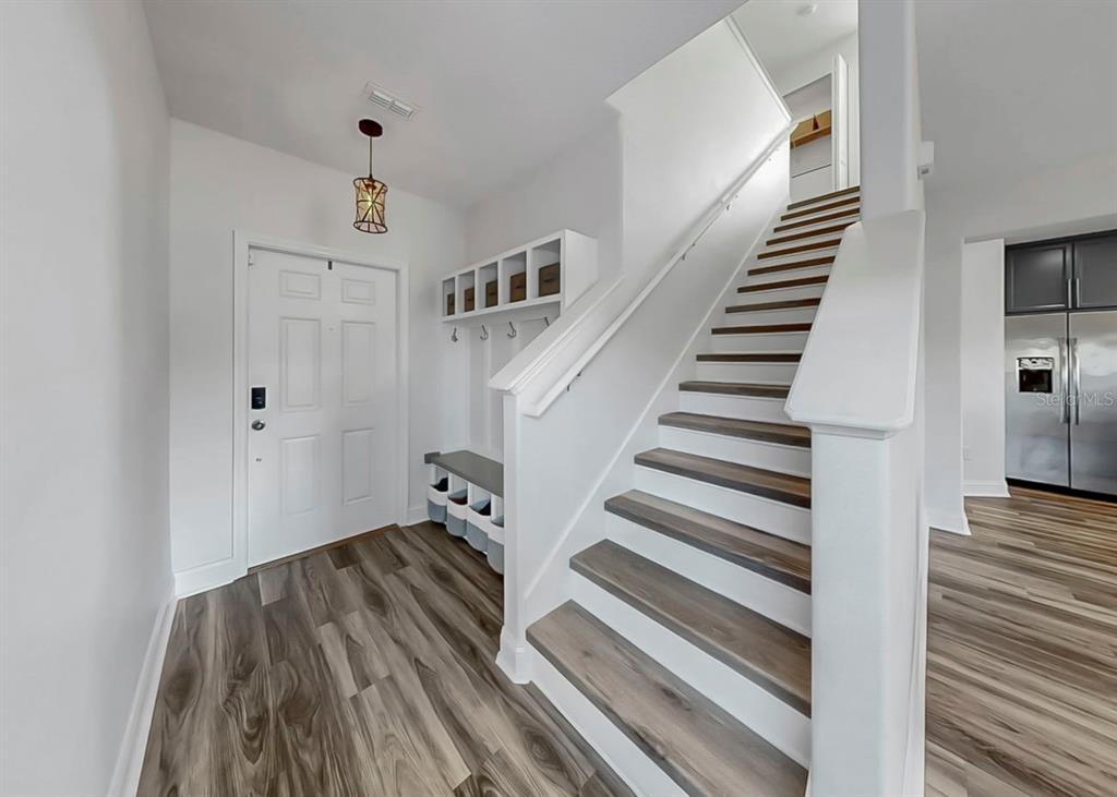 10136 Newminster Loop Ruskin, FL 33573 - Photo 50 of 64 a view of entryway and hall with wooden floor