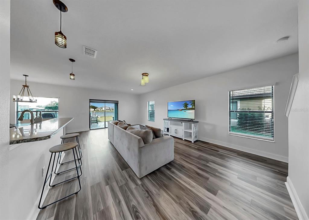 10136 Newminster Loop Ruskin, FL 33573 - Photo 5 of 64 a living room with furniture and a wooden floor
