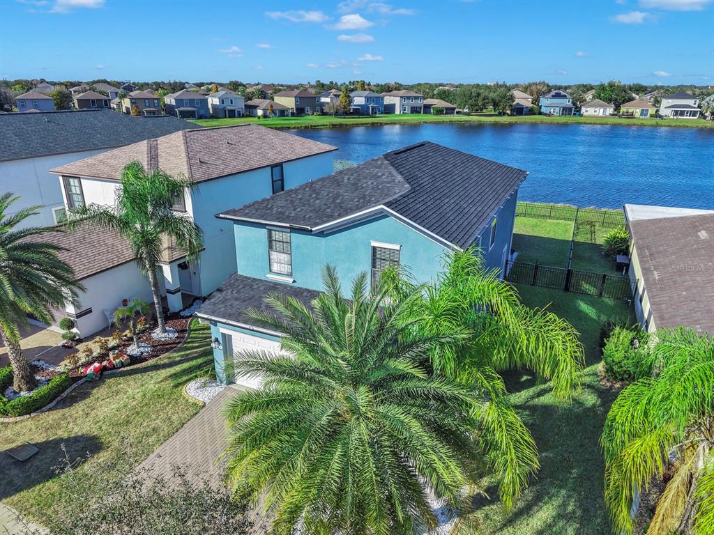 10136 Newminster Loop Ruskin, FL 33573 - Photo 57 of 64 an aerial view of a house with outdoor space and lake view in back