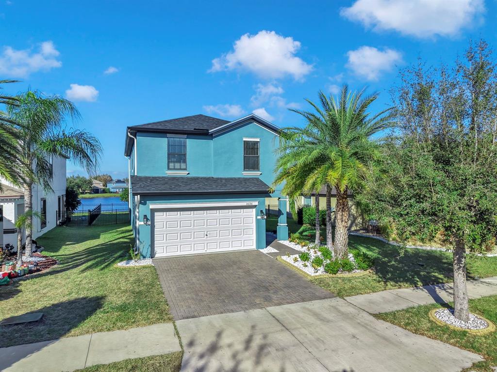 10136 Newminster Loop Ruskin, FL 33573 - Photo 64 of 64 a front view of a house with a yard and garage