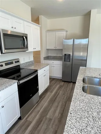 a kitchen with a sink stove and refrigerator