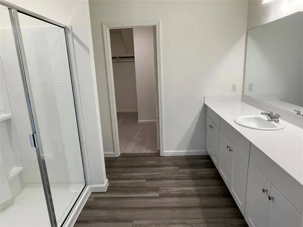 a bathroom with a double vanity sink and a mirror