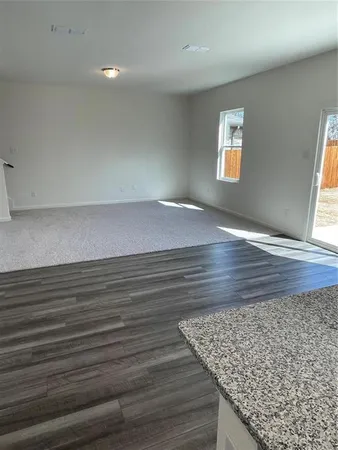 a view of wooden floor and windows in a room