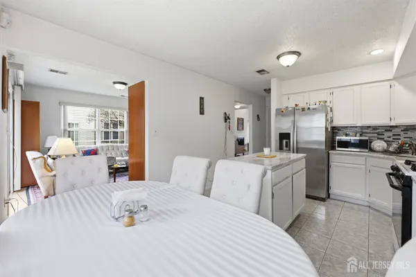 a bedroom with a bed a couch and dresser