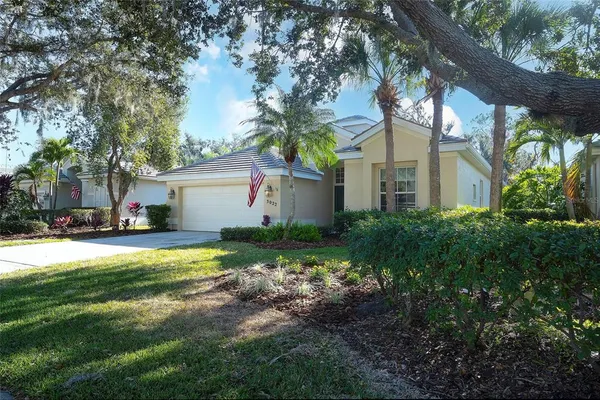 a front view of house with yard and trees