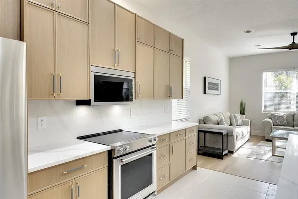 a kitchen with stainless steel appliances white cabinets and a stove top oven