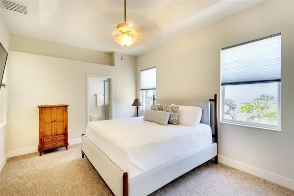 a bedroom with a bed and a painting on the wall