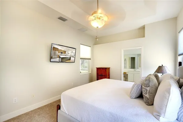 a bedroom with a bed and a chandelier
