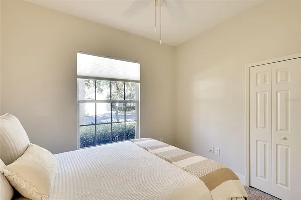 a bedroom with a bed and a window