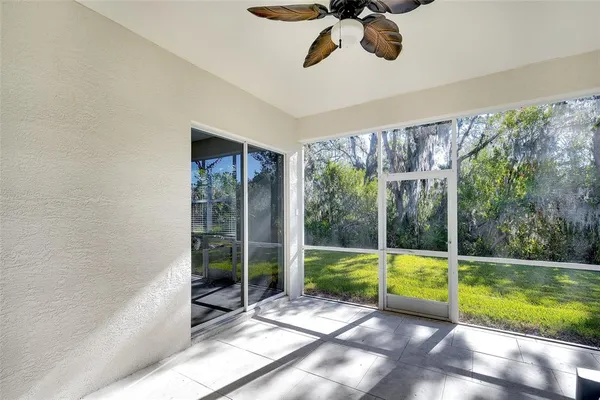 a view of an empty room with a balcony and floor to ceiling windows