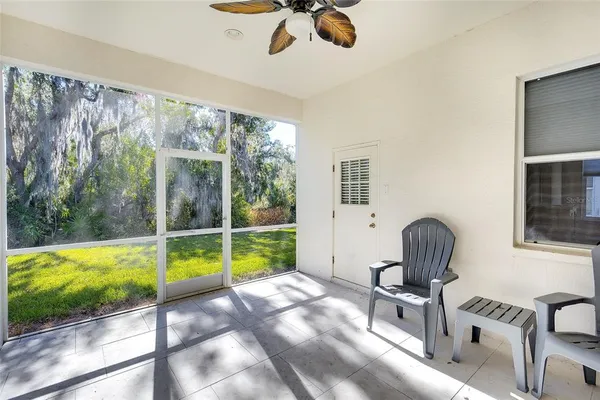 a view of a livingroom with furniture and a floor to ceiling window