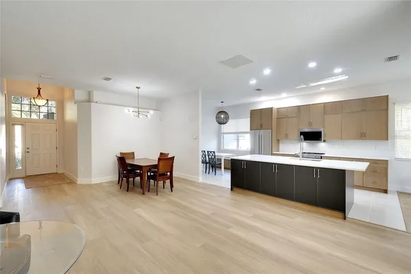 a large kitchen with stainless steel appliances lots of counter space and breakfast area