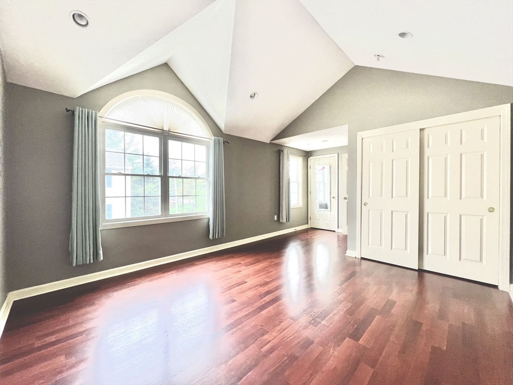1005 Trapelo Road, Unit 3 Waltham, MA 02452 - Photo 11 of 19 an empty room with wooden floor and windows