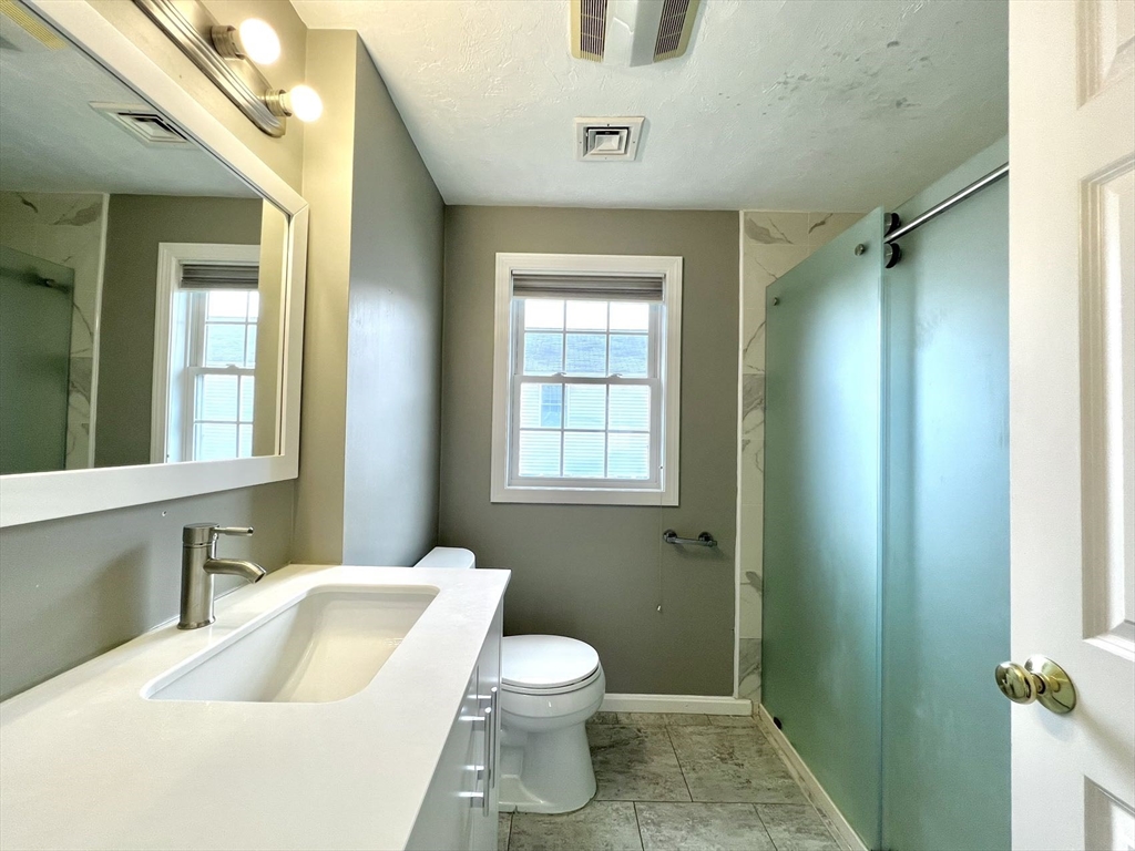 1005 Trapelo Road, Unit 3 Waltham, MA 02452 - Photo 14 of 19 a bathroom with a sink and toilet