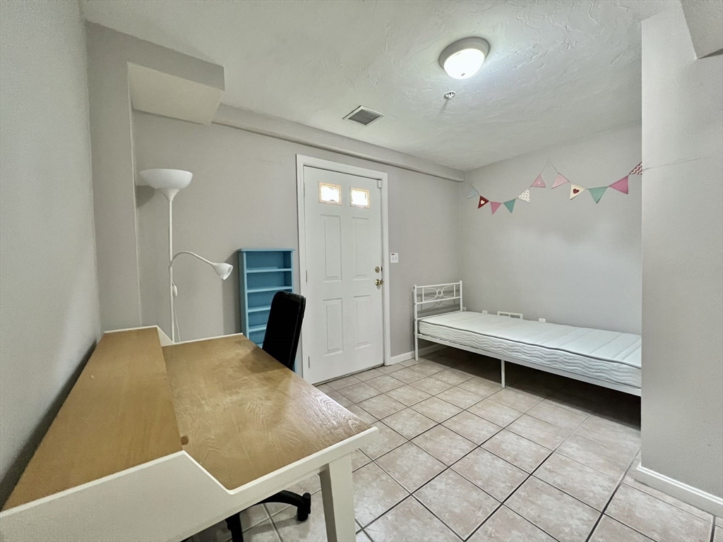 1005 Trapelo Road, Unit 3 Waltham, MA 02452 - Photo 16 of 19 a view of a room with furniture and wooden floor