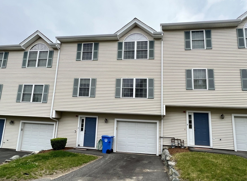 1005 Trapelo Road, Unit 3 Waltham, MA 02452 - Photo 18 of 19 a front view of a house with a yard and garage