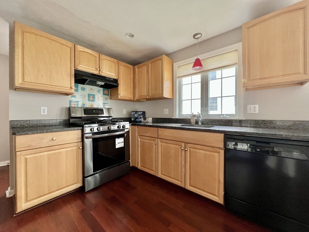 1005 Trapelo Road, Unit 3 Waltham, MA 02452 - Photo 2 of 19 a kitchen with stainless steel appliances granite countertop a stove a sink and a microwave