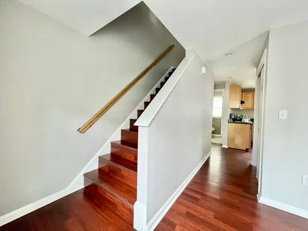 a view of entryway and hall with wooden floor