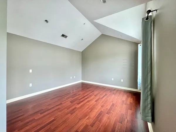 a view of a room with wooden floor