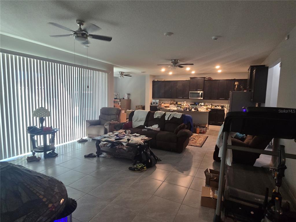 5846 Southwest 80th Lane Ocala, FL 34476 - Photo 14 of 27 a living room with furniture and a flat screen tv