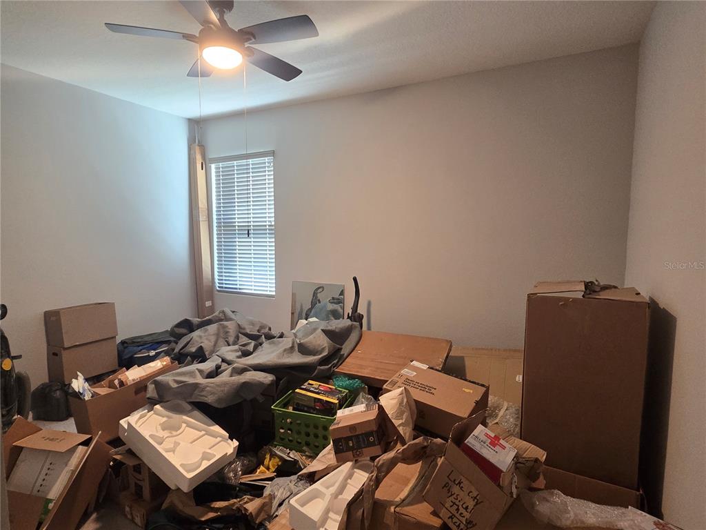 5846 Southwest 80th Lane Ocala, FL 34476 - Photo 17 of 27 a bedroom with a bed and wooden floor