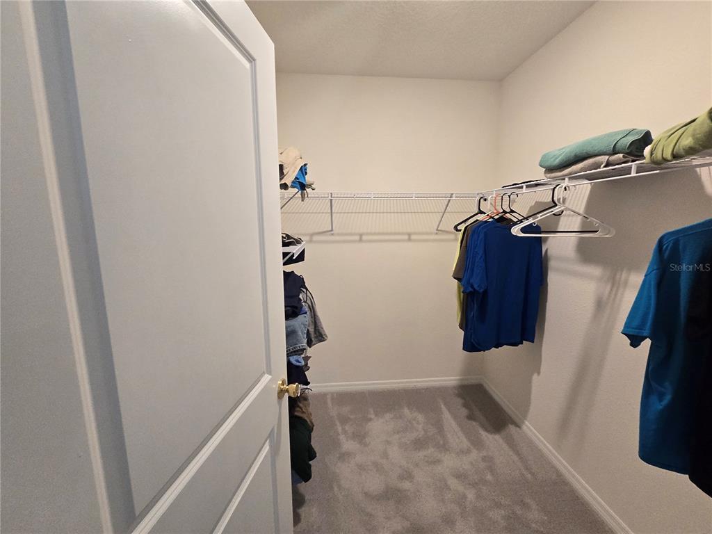 5846 Southwest 80th Lane Ocala, FL 34476 - Photo 19 of 27 a view of walk in closet with clothes and shoes