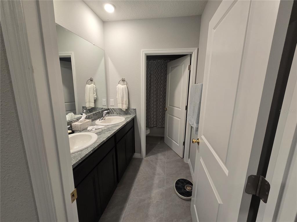 5846 Southwest 80th Lane Ocala, FL 34476 - Photo 21 of 27 a bathroom with sink and mirror