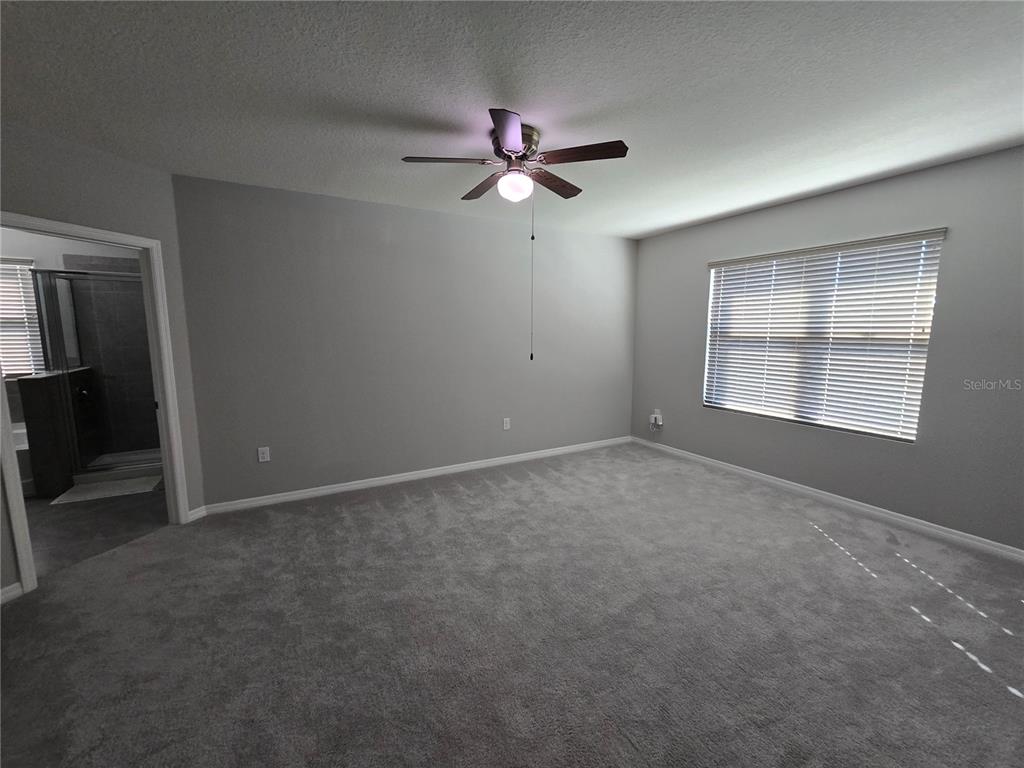 5846 Southwest 80th Lane Ocala, FL 34476 - Photo 22 of 27 an empty room with windows and fan