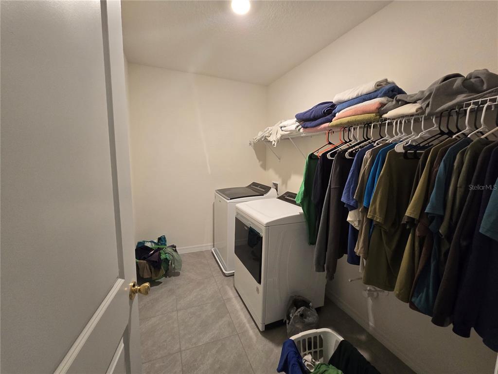 5846 Southwest 80th Lane Ocala, FL 34476 - Photo 26 of 27 a view of walk in closet with clothes and shoes