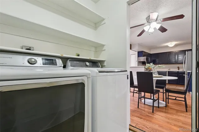 a kitchen with stainless steel appliances a table chairs and a refrigerator