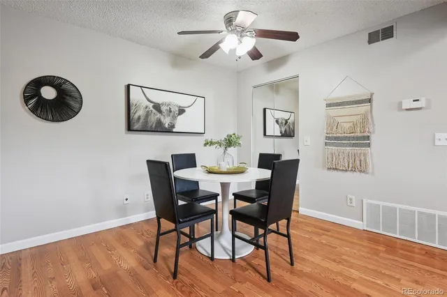 a view of a dining room with furniture wooden floor and chandelier