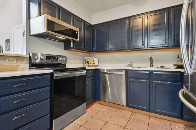 a kitchen with stainless steel appliances granite countertop a sink and cabinets