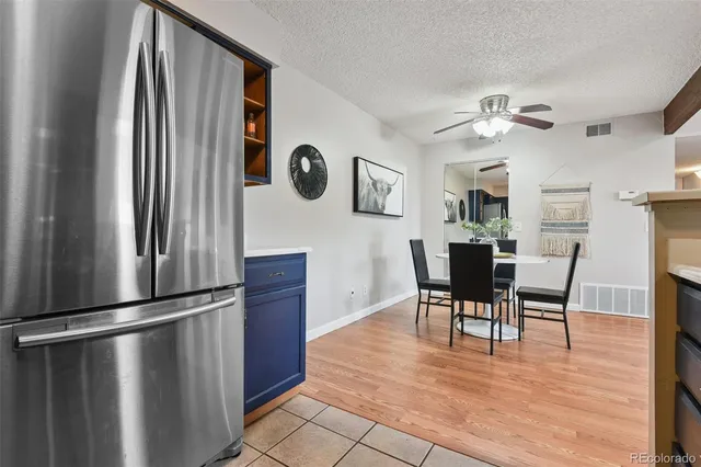 a view of a dining room with furniture a chandelier and wooden floor
