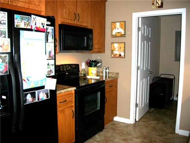 5 Myrick Road Flintville, TN 37335 - Photo 7 of 13 a kitchen with stainless steel appliances granite countertop a refrigerator stove and microwave