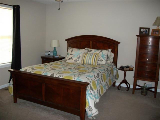 5 Myrick Road Flintville, TN 37335 - Photo 8 of 13 a bedroom with a bed and a lamp on table