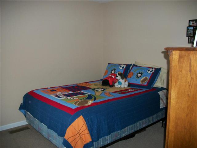 5 Myrick Road Flintville, TN 37335 - Photo 10 of 13 a bed room with a bed and a table