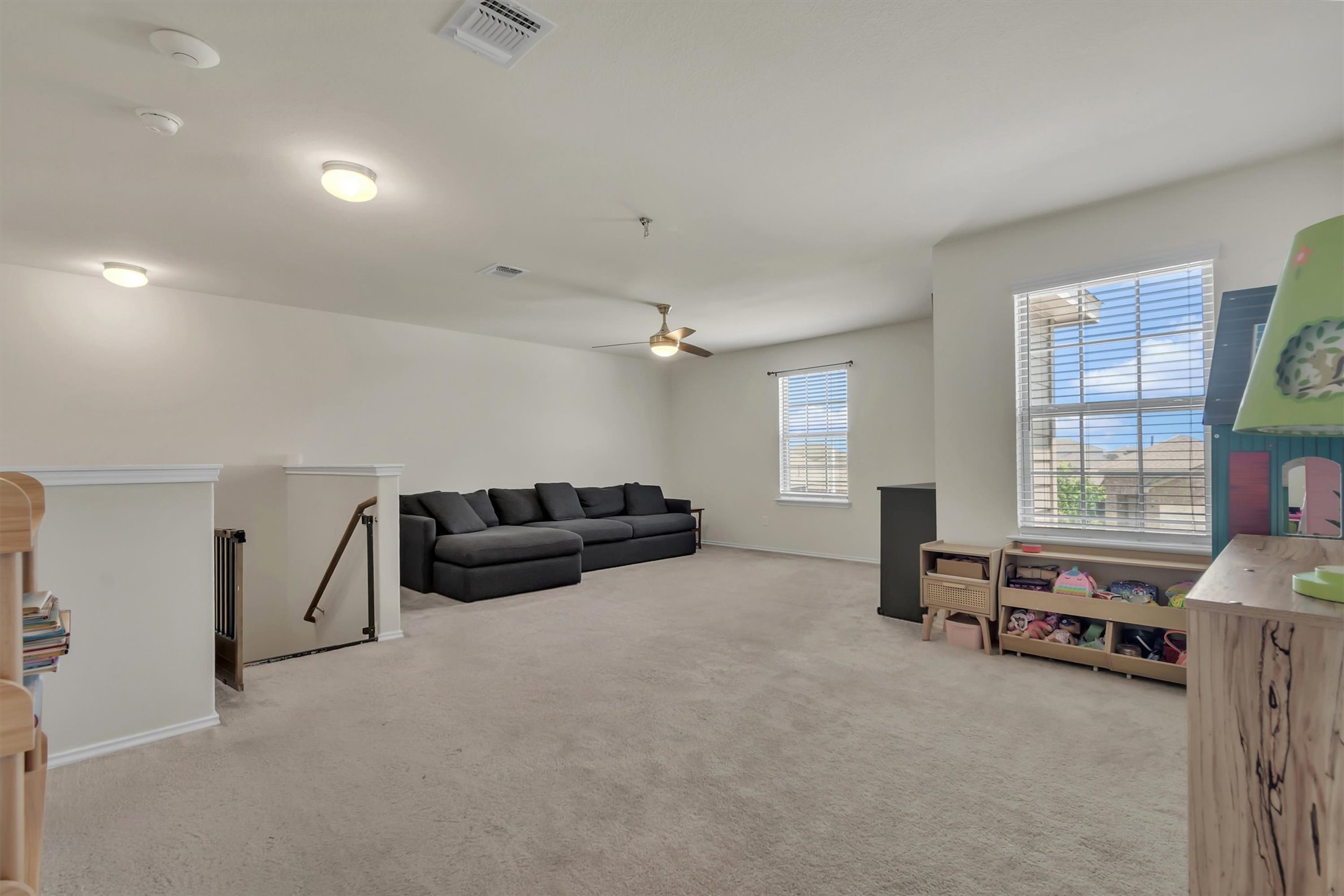 11701 Jackson Falls Way Manor, TX 78653 - Photo 28 of 40 A spacious secondary living area perfect for relaxation, featuring soft carpet flooring and abundant natural light.
