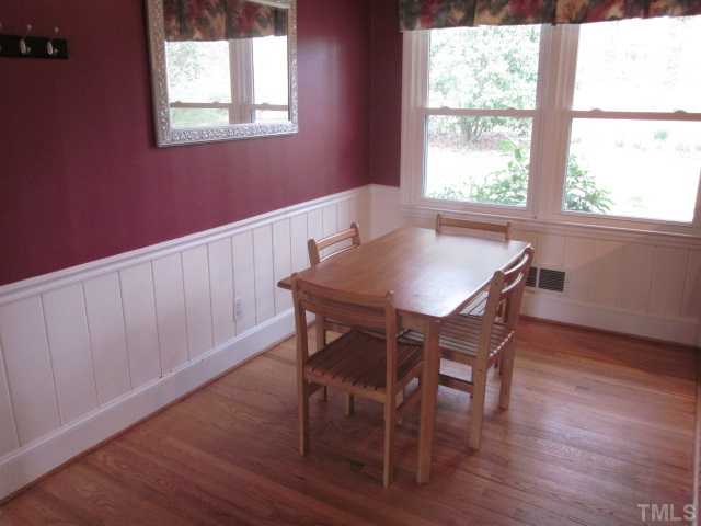 5316 Barclay Drive Raleigh, NC 27606 - Photo 11 of 25 Great breakfast area located just off the kitchen! Breakfast area features crown & chair rail moldings, hardwood floors, original wainscoting and ceiling fan! Nice view into the yard!