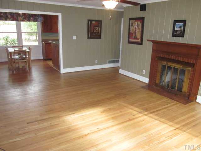 5316 Barclay Drive Raleigh, NC 27606 - Photo 13 of 25 Wonderful living room features include masonry fireplace with gas logs, hardwood floors, crown moldings. painted knotty pine walls, surround sound speakers and updated ceiling fan with light!